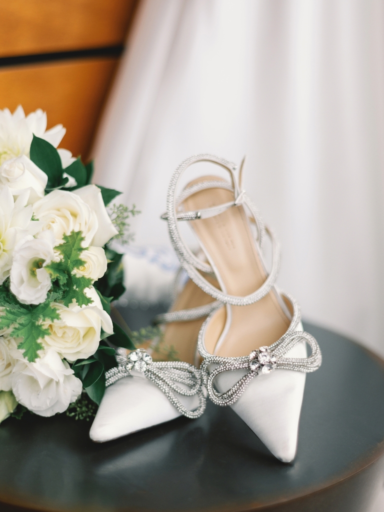 white bridal shoes with silver bow